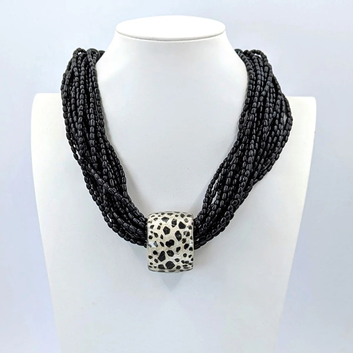 Resin tube pendant with multi wooden bead strand statement necklace in Black & Pearl