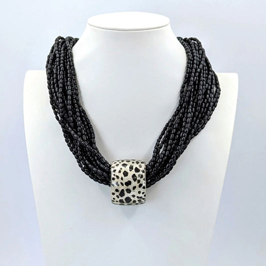 Resin tube pendant with multi wooden bead strand statement necklace in Black & Pearl