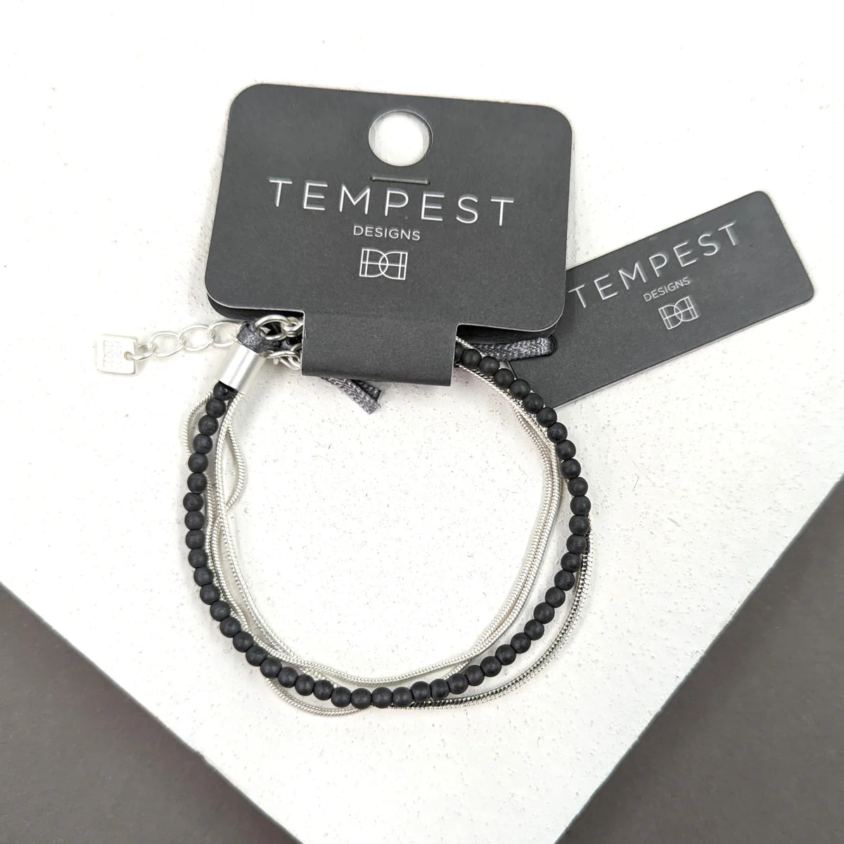 Multi Strand Silver Coloured Snake Bracelet With Grey Beaded Detail